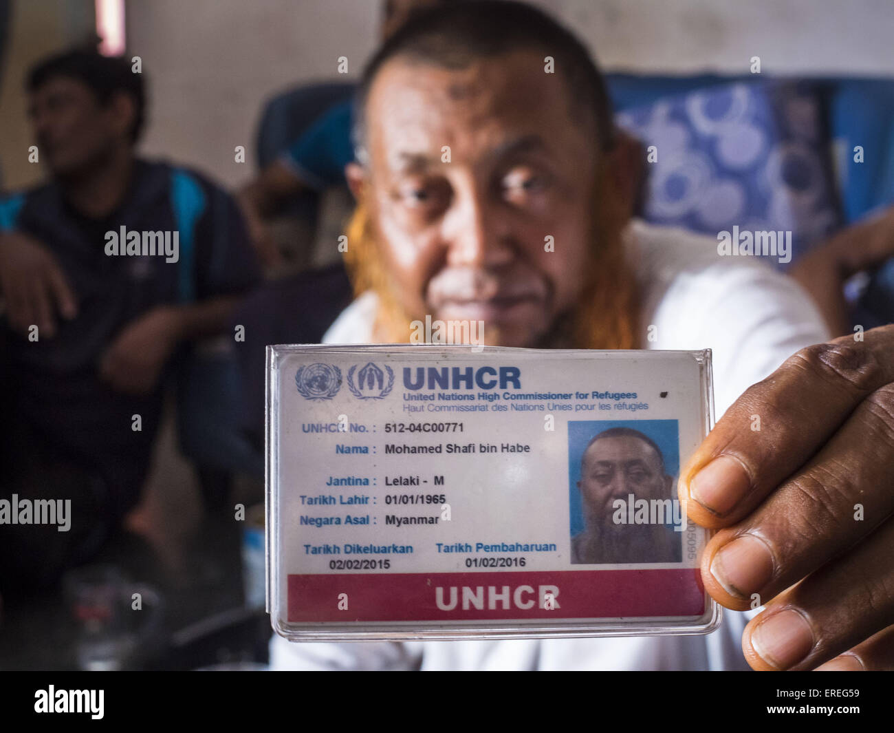 June 1, 2015 - Kulai, Johore, Malaysia - MOHAMED SHAFI bin HABE, a prominent member of the Rohingya community in Kulai, Malaysia, holds up his UNHCR card. The UN says the Rohingya, a Muslim minority in western Myanmar, are the most persecuted ethnic minority in the world. The government of Myanmar insists the Rohingya are illegal immigrants from Bangladesh and has refused to grant them citizenship. Most of the Rohingya in Myanmar have been confined to Internal Displaced Persons camp in Rakhine state, bordering Bangladesh. Thousands of Rohingya have fled Myanmar and settled in Malaysia. © ZUMA  Stock Photo