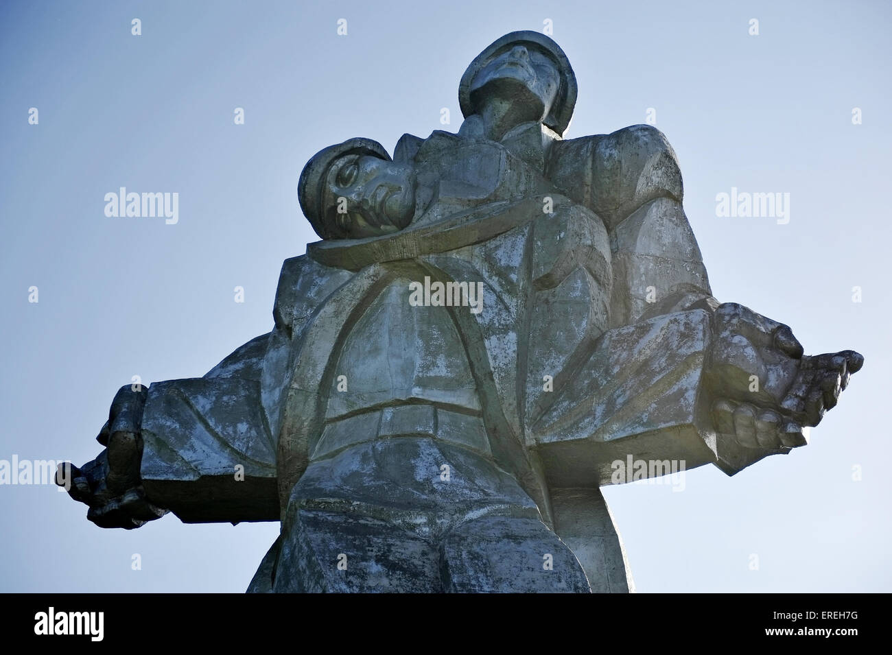 Huge soviet silver statue of a soldier holding a dying comrade representing the World War Two Memorial in Dilijan, Armenia. Stock Photo