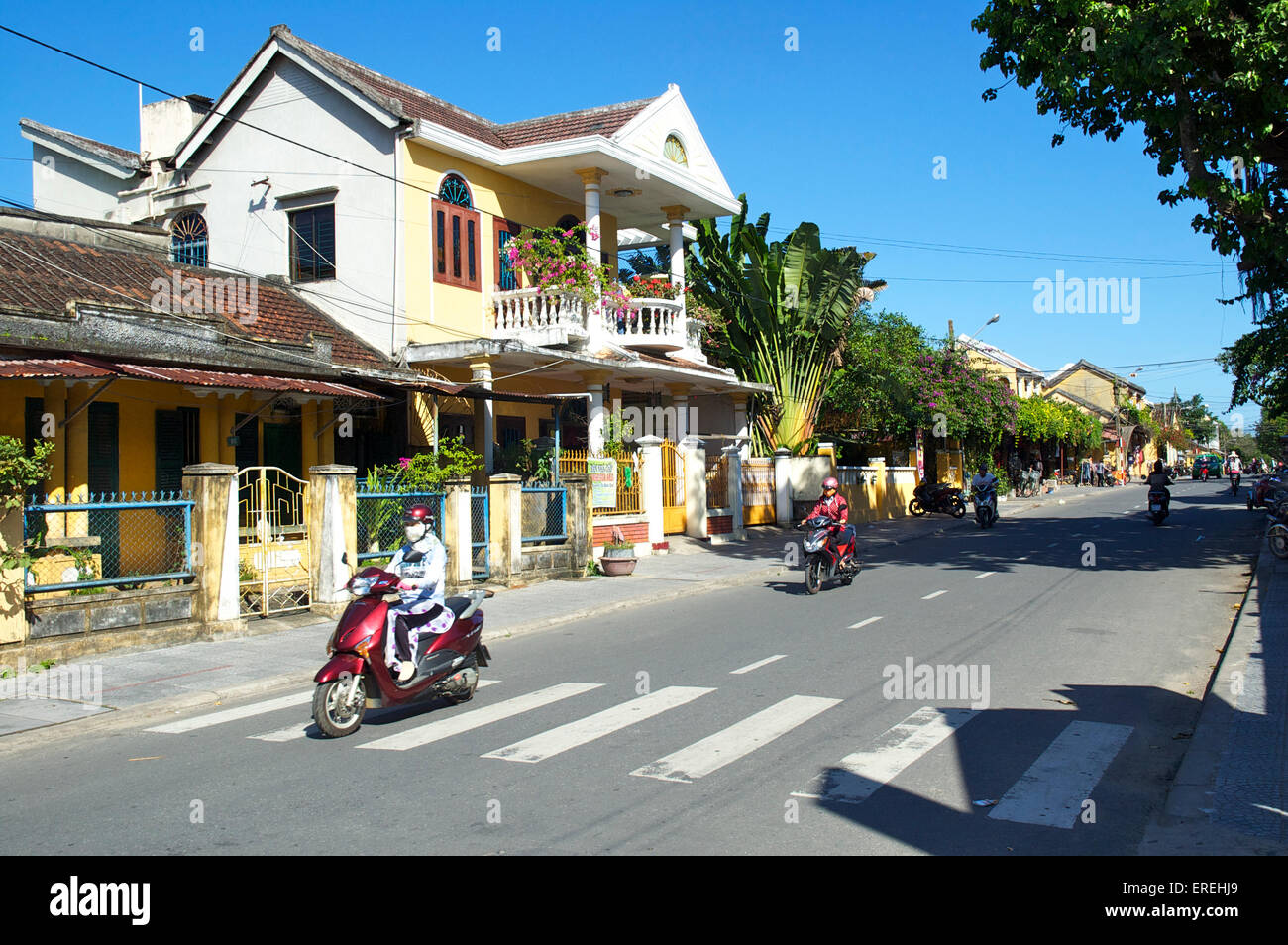 Moped riders on a street in Hoi An, Vietnam Stock Photo - Alamy