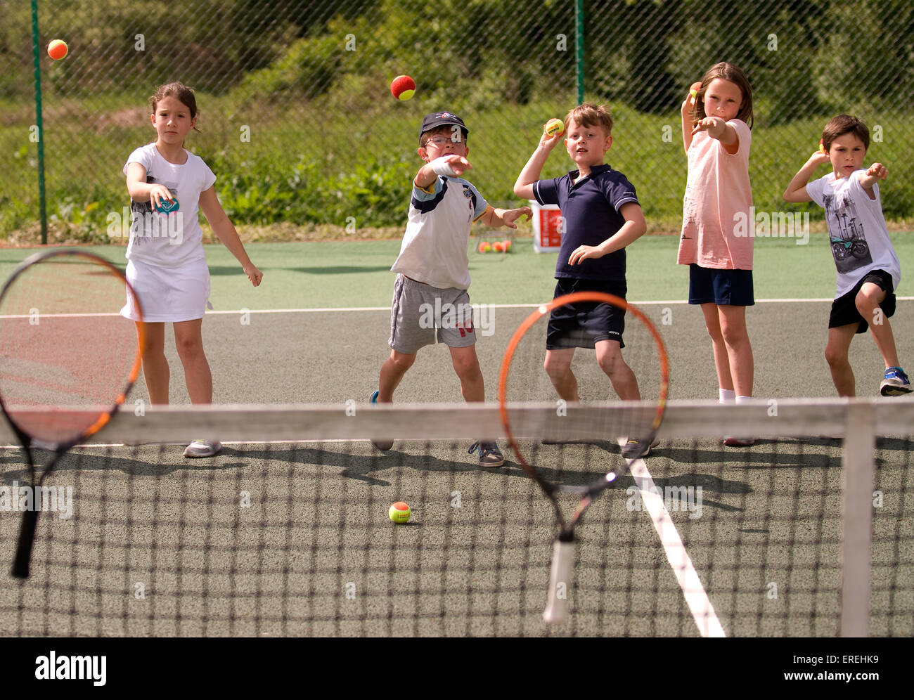 Kids playing tennis games at a charity tennis event, Headley, Hampshire, UK  Stock Photo - Alamy