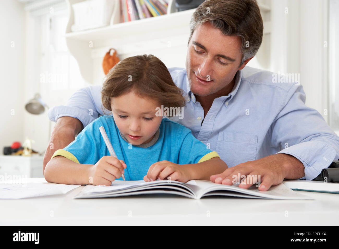 Father Helping Son With Homework Stock Photo - Alamy
