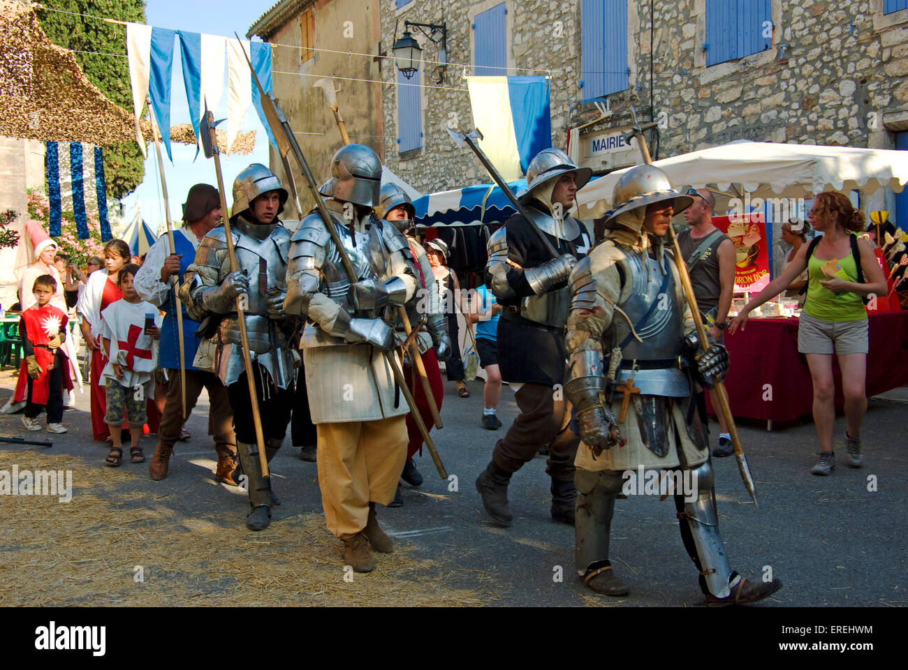 Group of medieval soldiers in armour , marching through the streets of the village of Aiguèze in the Ardèche region, southern Stock Photo