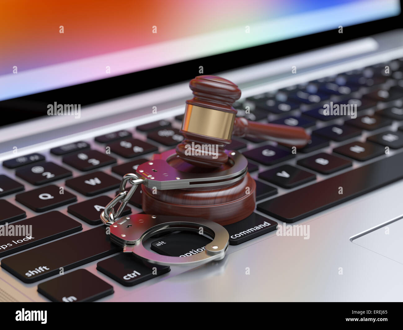 3d render of handcuffs and judge gavel on the laptop keyboard with soft focus Stock Photo