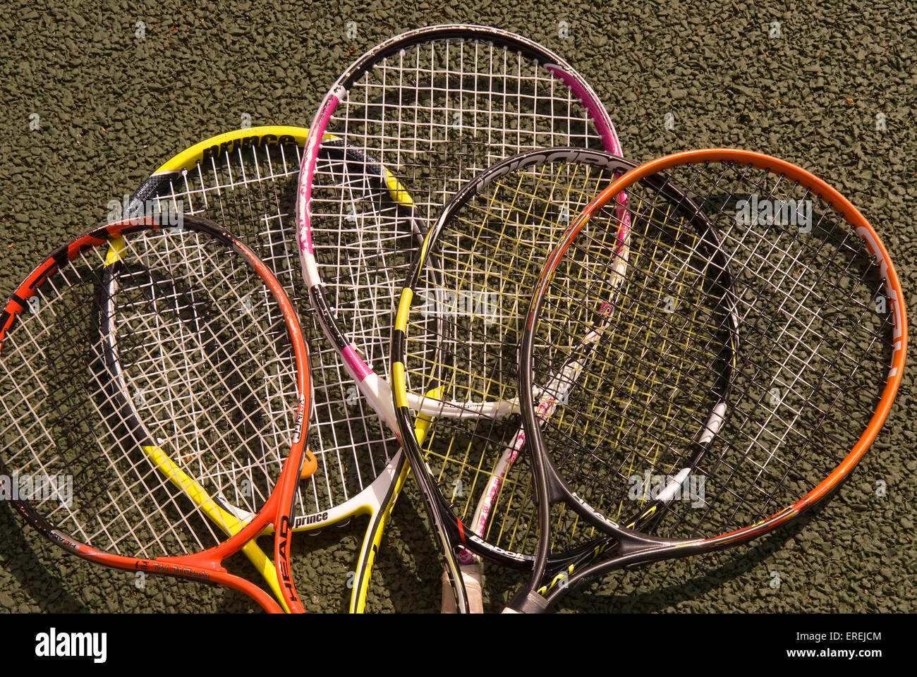 Assortment of tennis rackets laying on tennis court, Headley, Hampshire, UK. Stock Photo