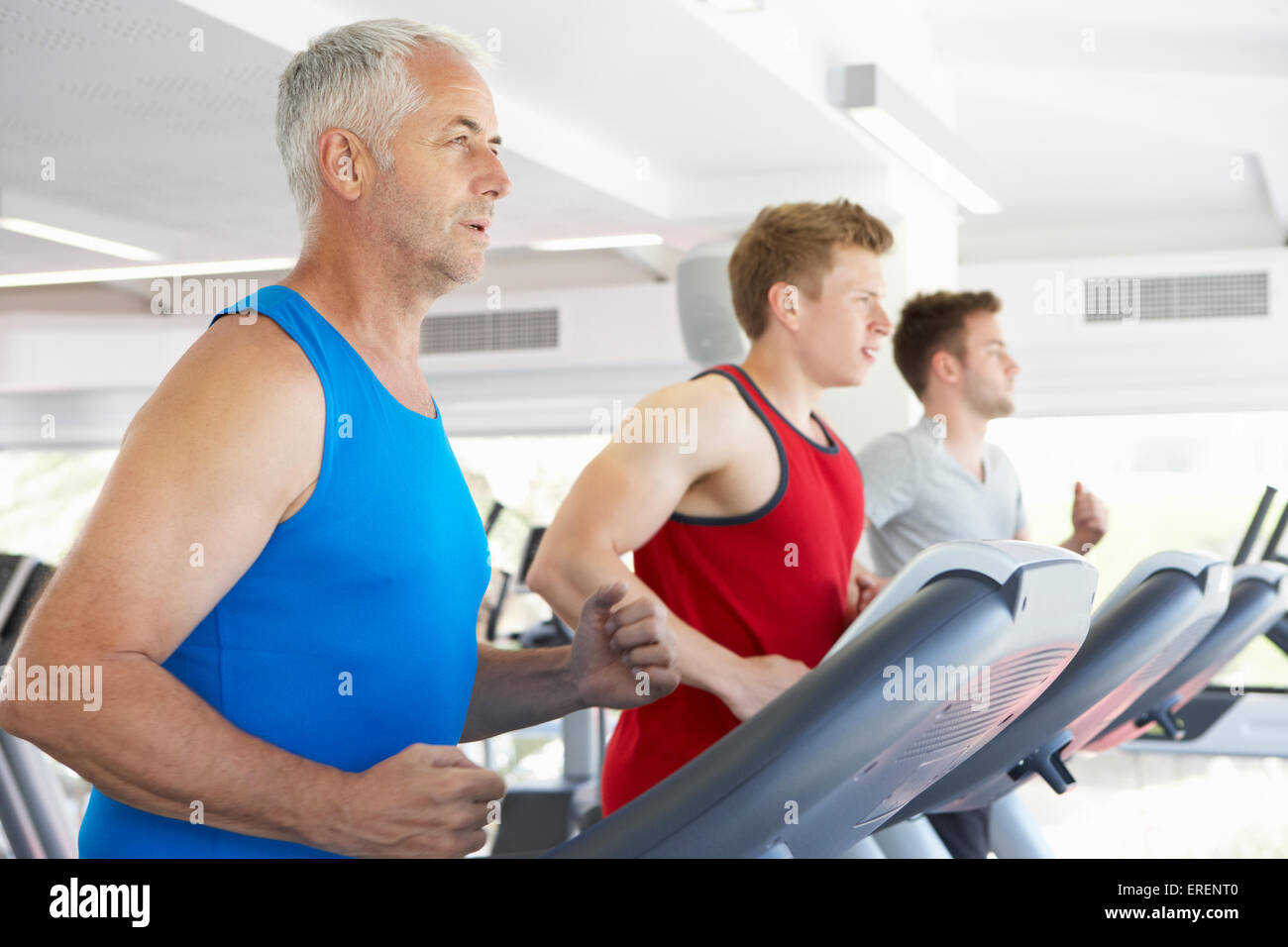 Group Of Men Using Running Machines In Gym Stock Photo - Alamy