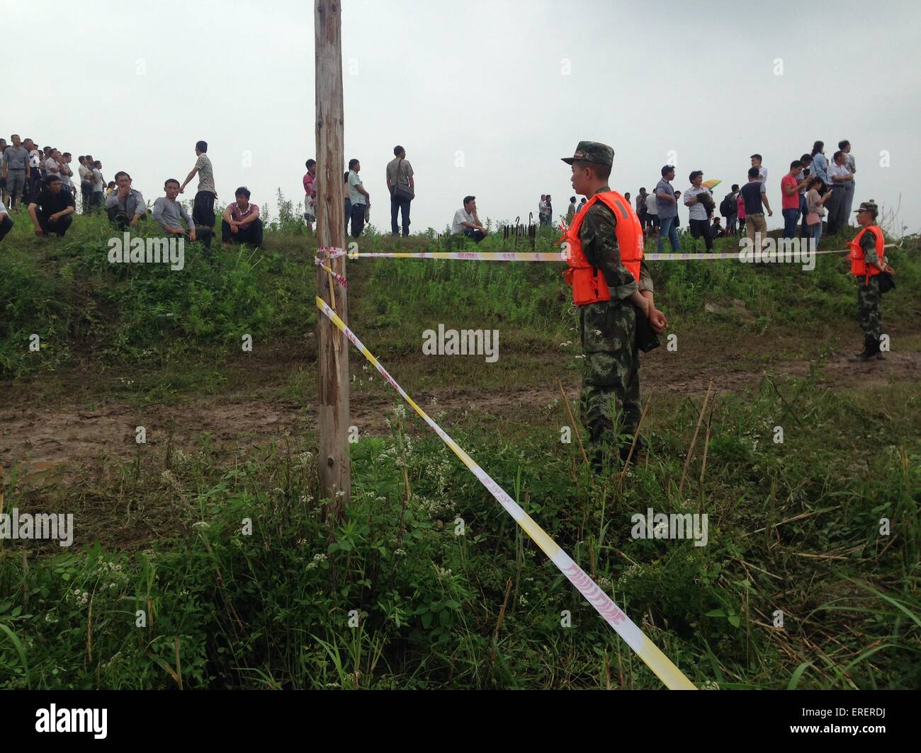 Jianli, China. 2nd of June, 2015. Soldiers stand  near the security cordon  at the site near the overturned passenger ship in the Jianli section of the Yangtze River , Hubei province, central China on  June 2, 2015. The ship, Carrying 406 passengers, five travel agency workers and 47 crew members,sank at around 9:28 p.m. (1328 GMT) on Monday,  according to the Xinhua News Agencey Said. Credit:  Panda Eye/Alamy Live News Stock Photo