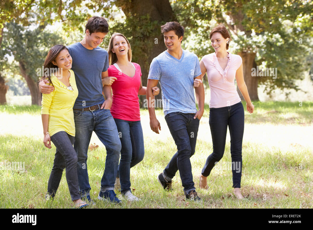 Group Of Young Friends Walking Through Countryside Stock Photo - Alamy