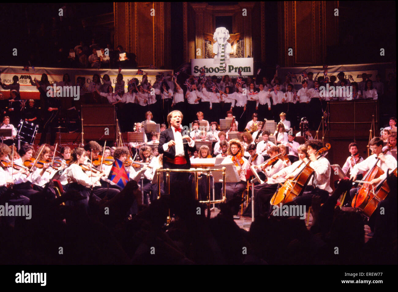 Antony Hopkins CBE  conducting  youth orchestra during the finale of one of the Schools Prom concerts, Royal Albert Hall, Stock Photo