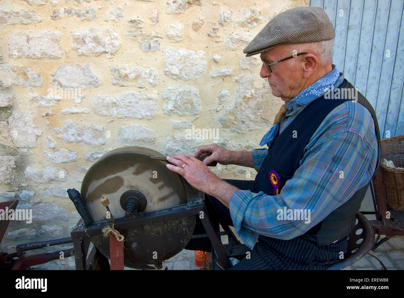 Traditional knife-grinder demonstrating his skills in the village of ...