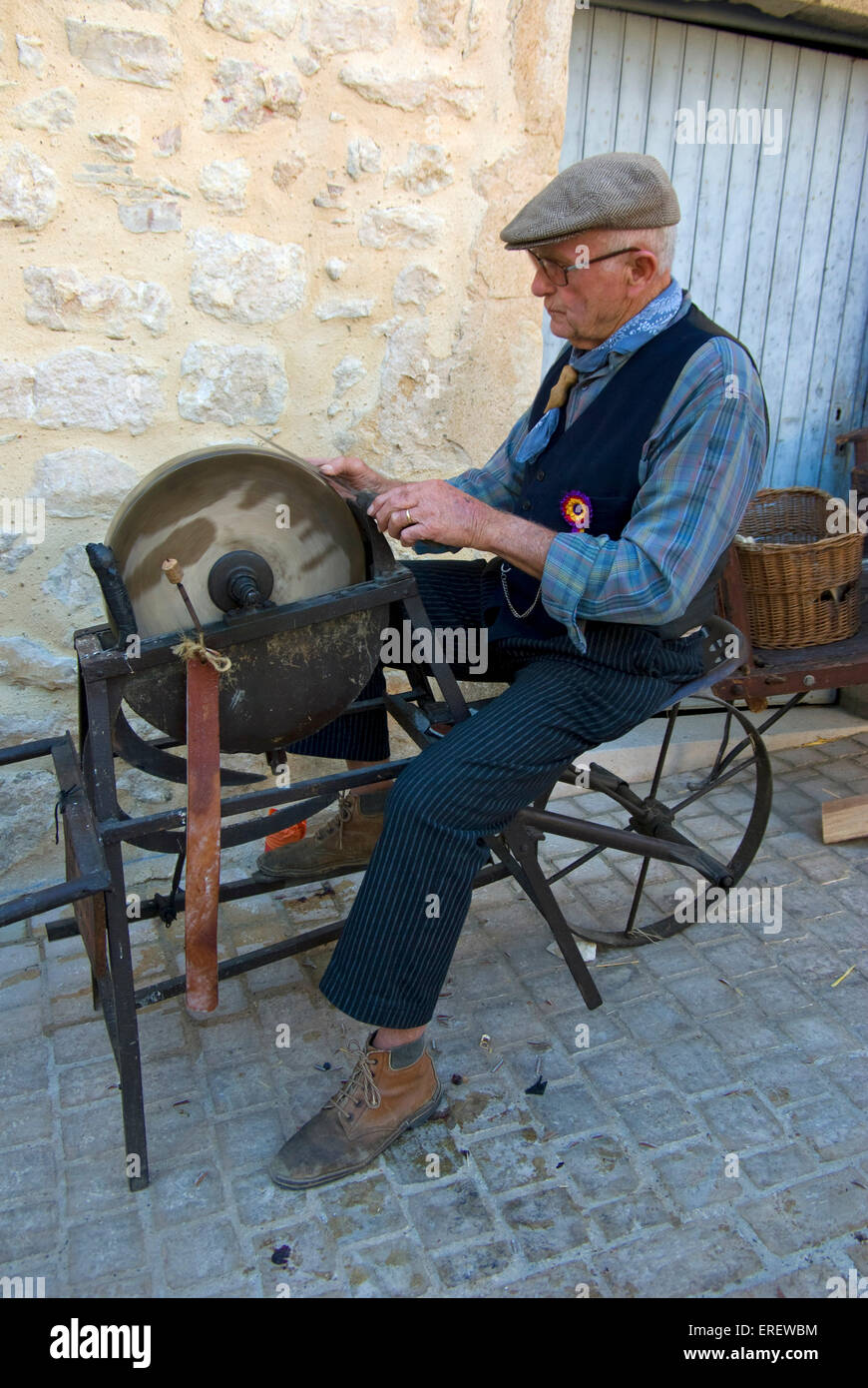 Traditional knife-grinder demonstrating his skills in the village of ...