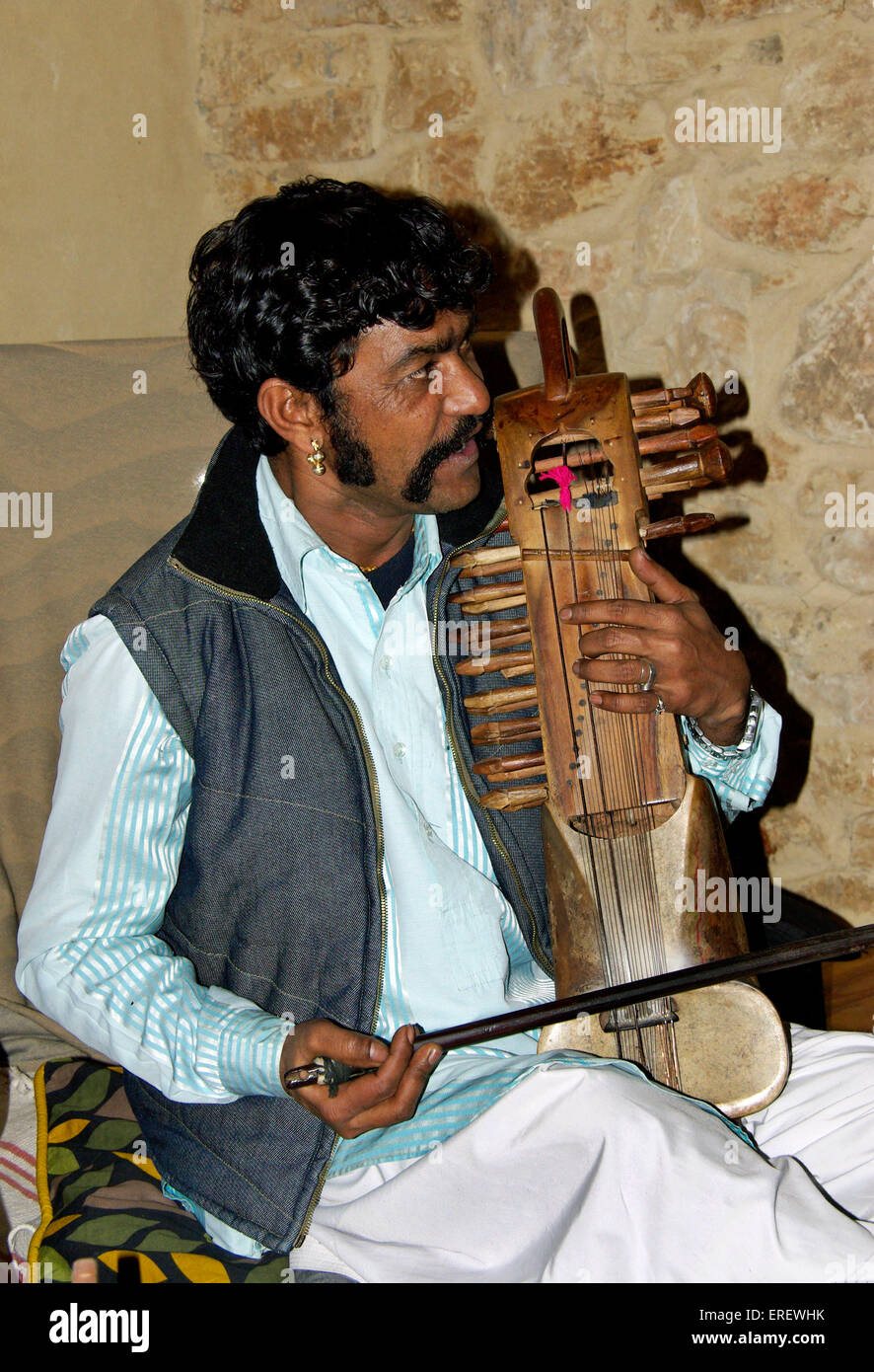 Indian singer and sarangi player performing in a private setting. The