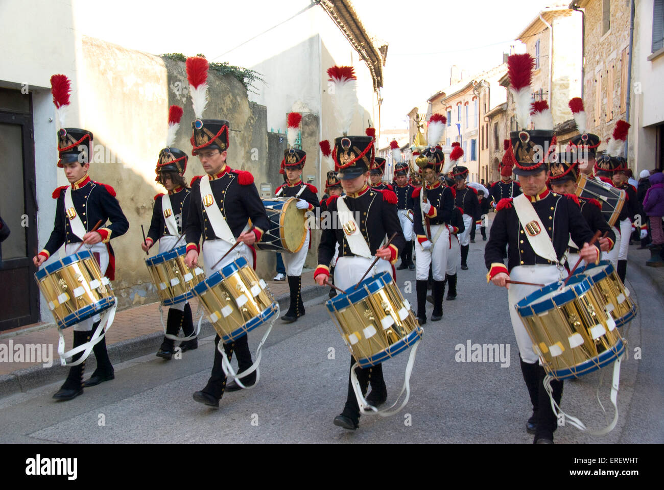 Dummers of the Musique du Tambour d'Arcole in Napoleonic light infantry uniform marching in the village of Roquemaure, Southern France. Stock Photo
