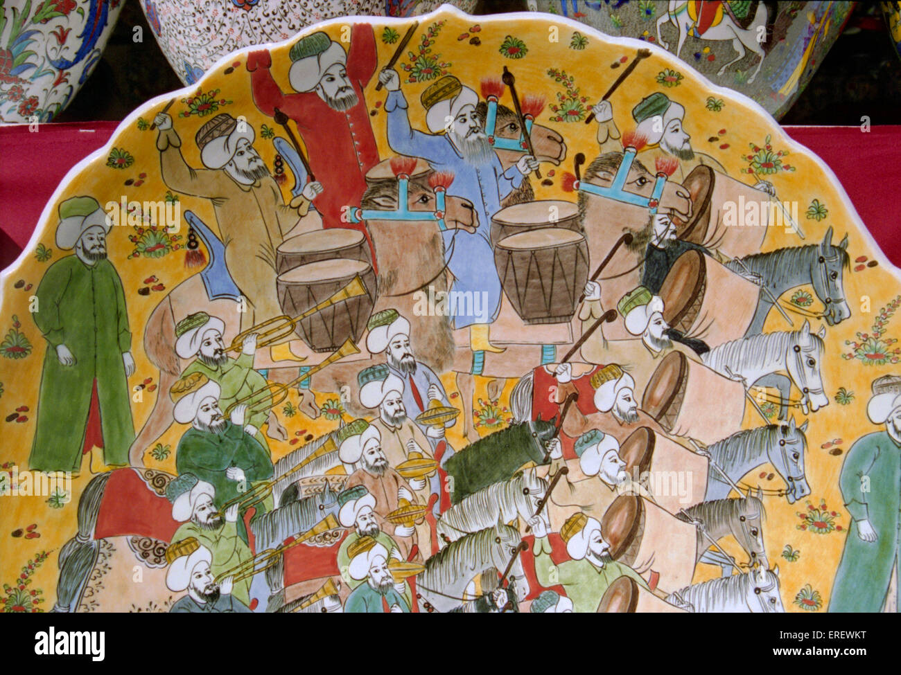 Detail of painted plate showing Turkish musicians  mounted on horses and camels and playing drums, trumpets and cymbals. Stock Photo