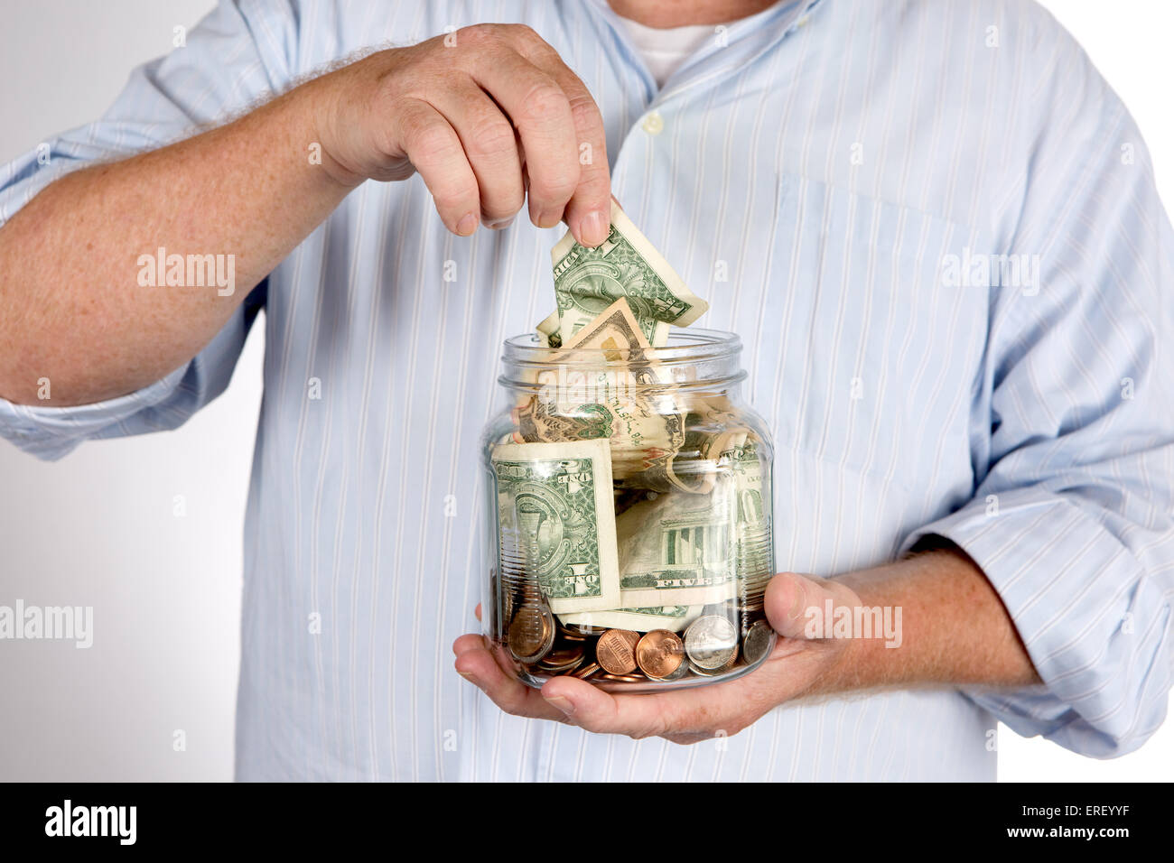 Retiree withdraws money from his savings, bank, or IRA account piggy bank concept. Stock Photo