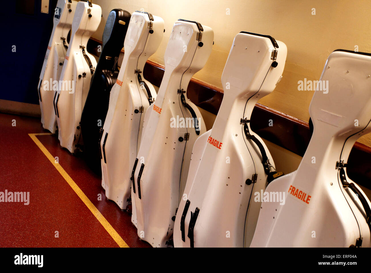 Line of cello cases, flight cases for musical instruments Stock Photo
