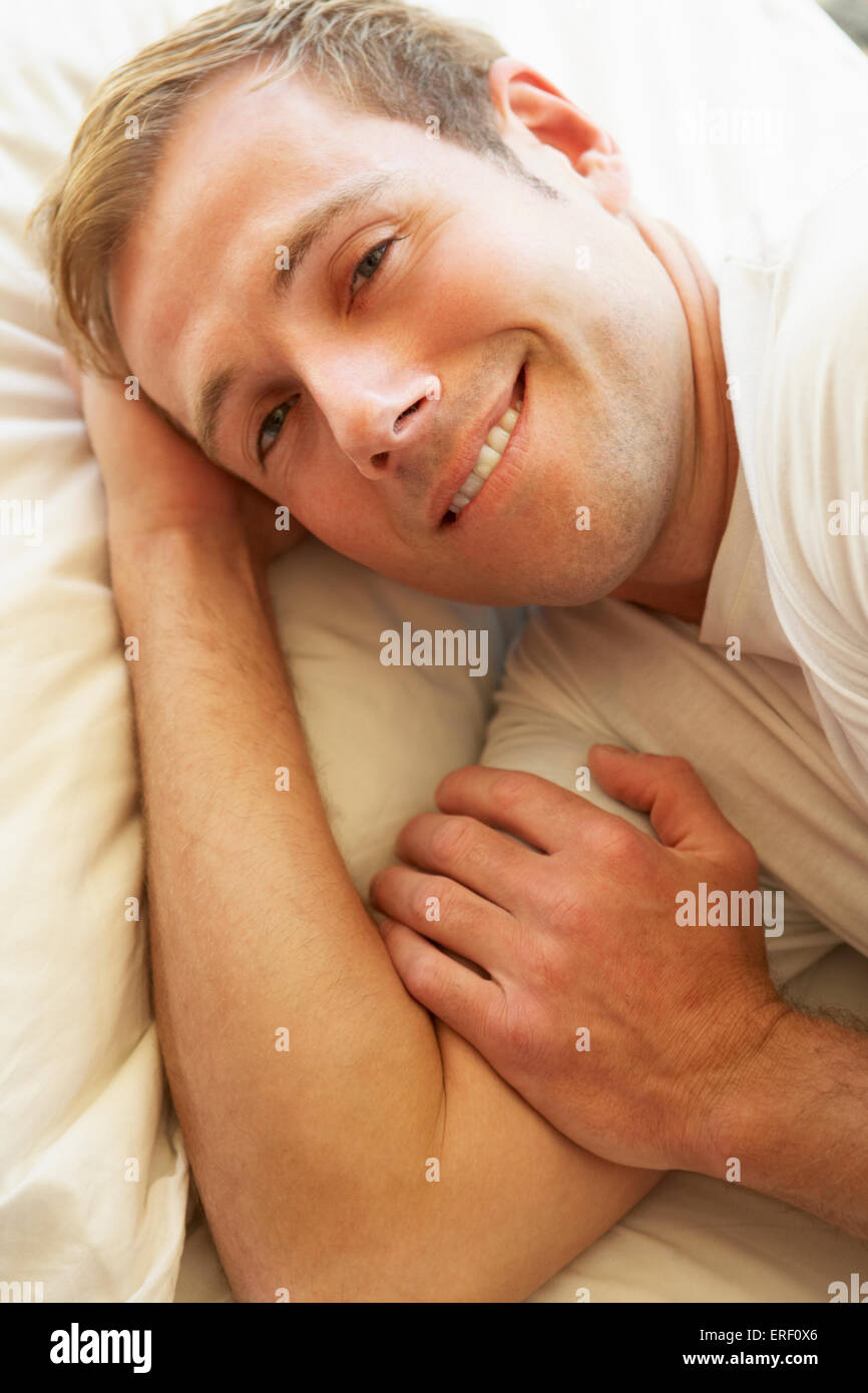 Man Relaxing In Bed Stock Photo
