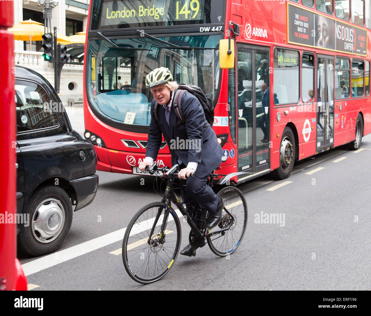London Mayor,Boris Johnson,cycling past Liverpool street station on his way to Westminster Stock Photo