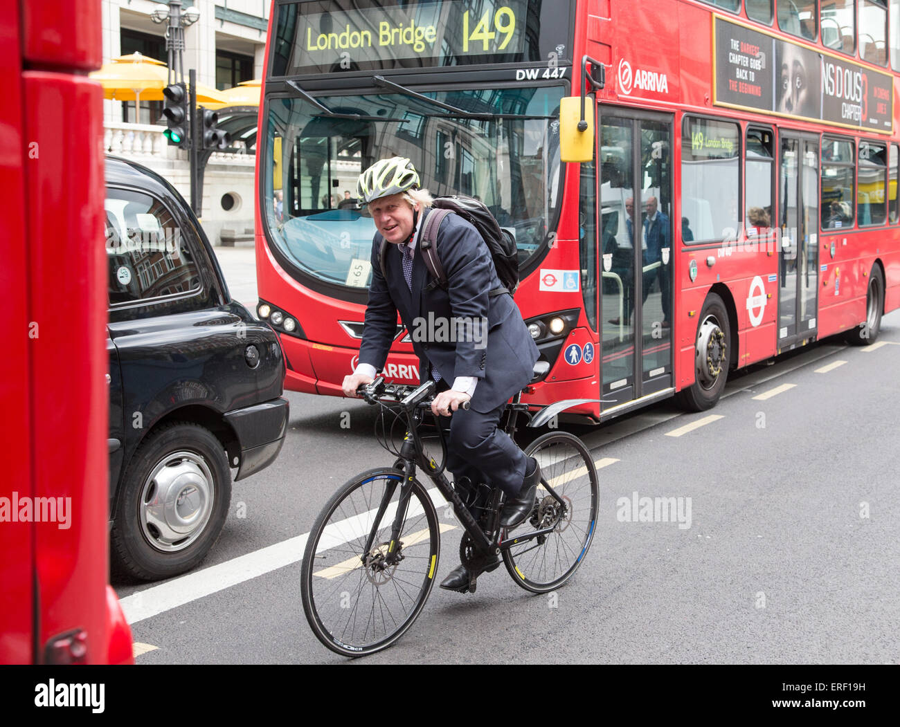 London Mayor,Boris Johnson,cycling past Liverpool street station on his way to Westminster Stock Photo