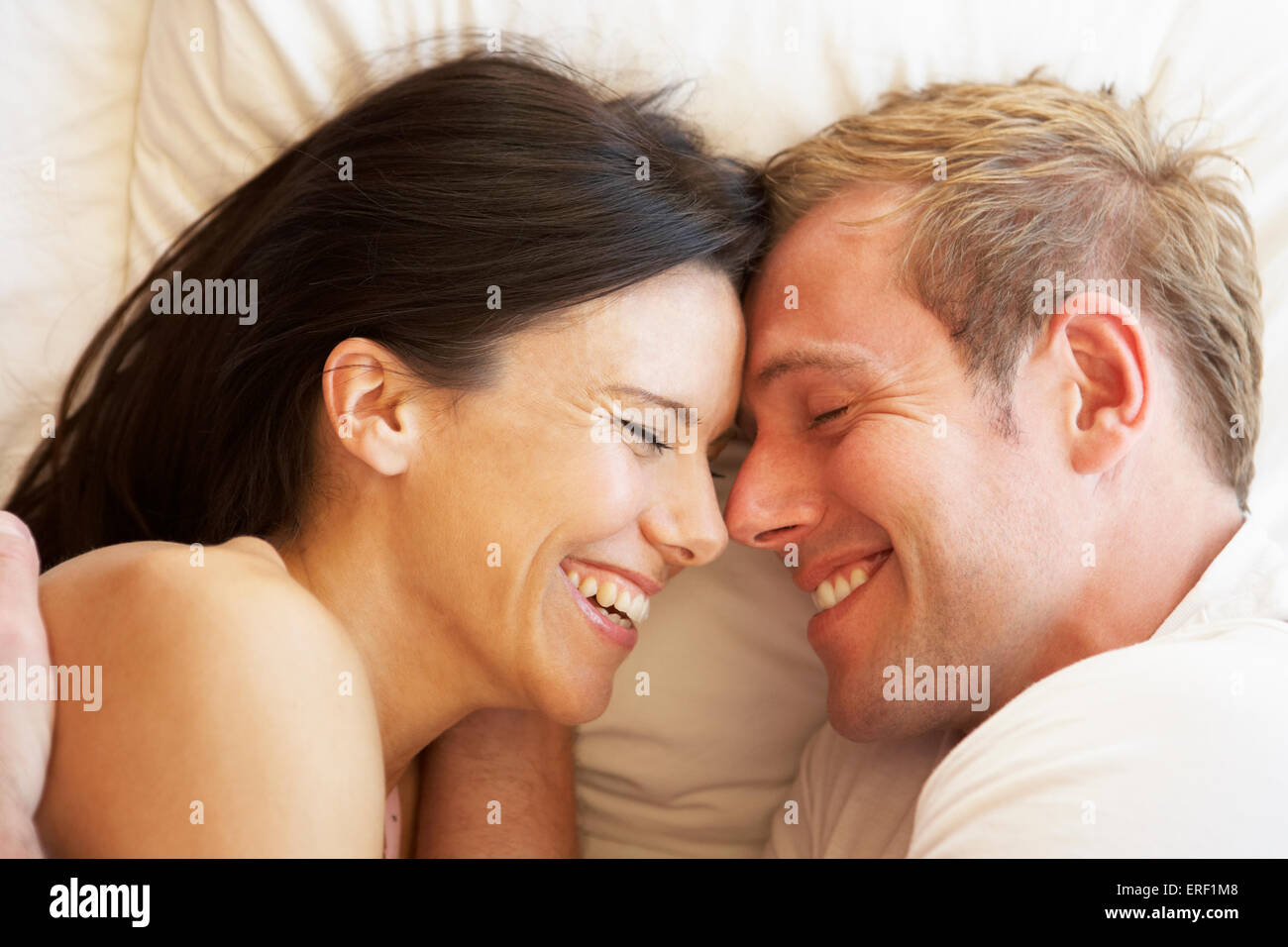 Couple Relaxing In Bed Stock Photo