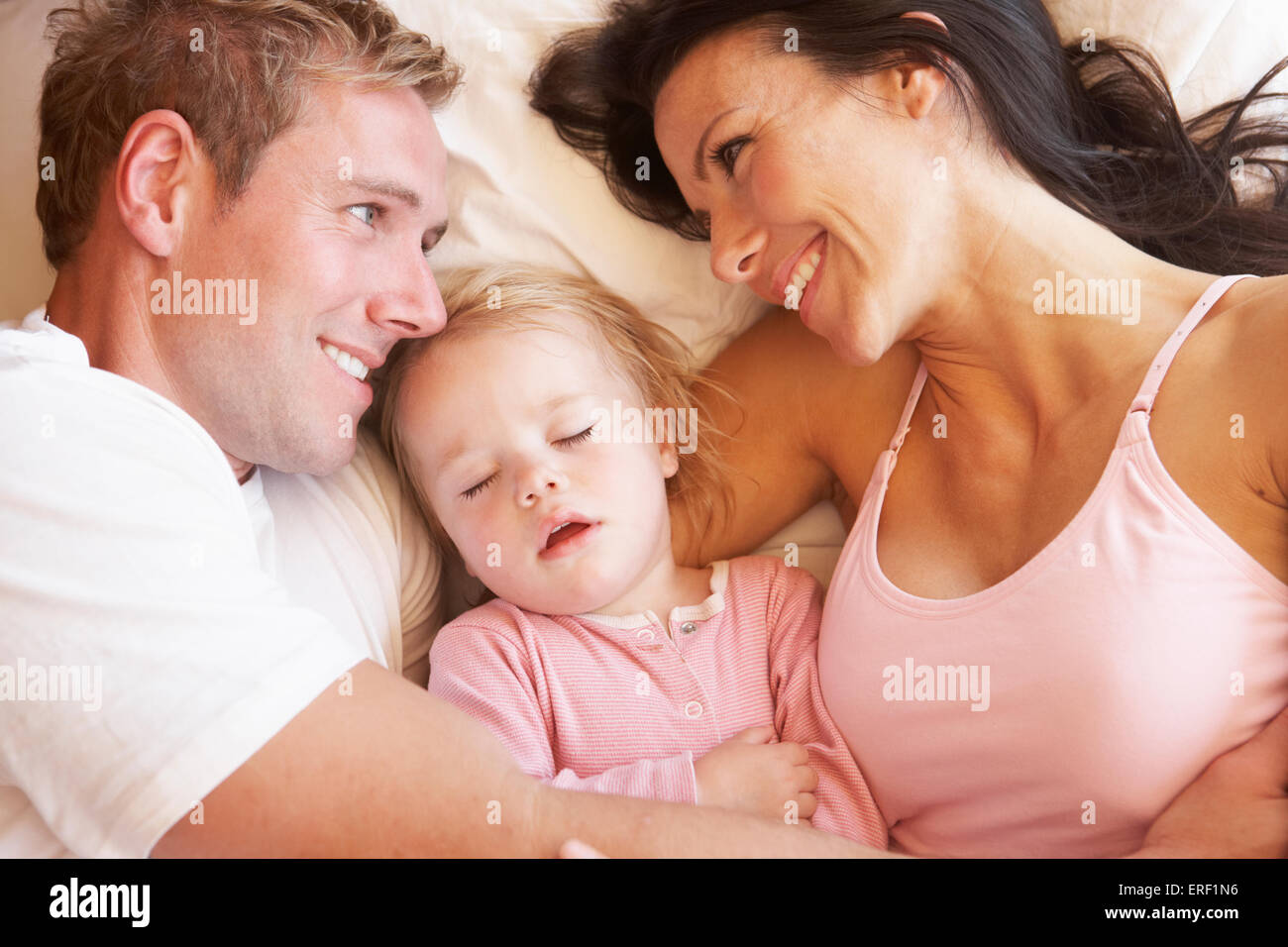 Family Relaxing In Bed Stock Photo