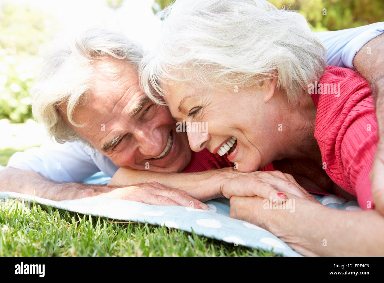 Senior Couple Relaxing In Park Together Stock Photo - Alamy