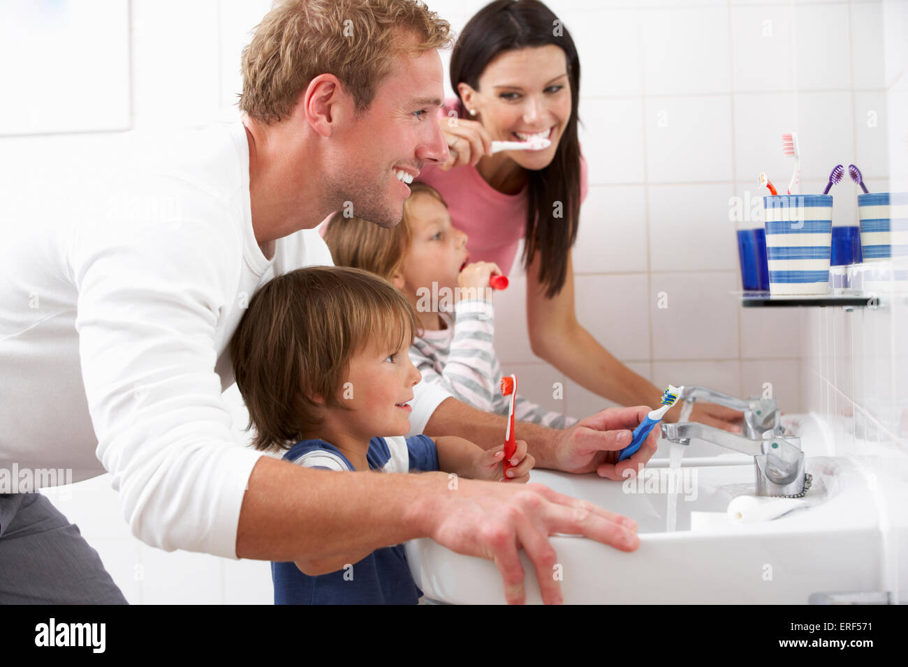 Family In Bathroom Brushing Teeth Stock Photo Alamy