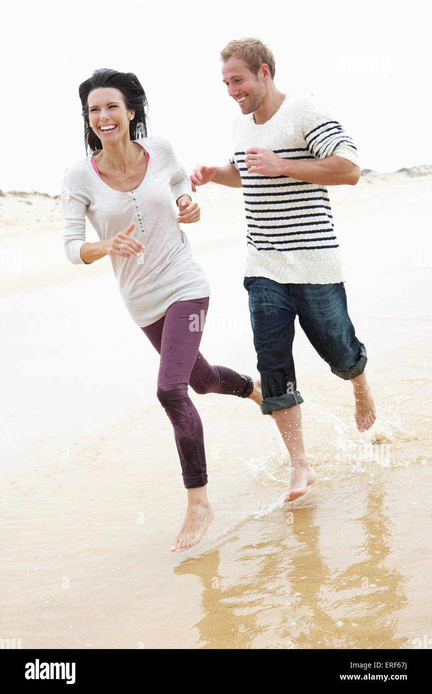 Couple Running Along Beach Together Stock Photo Alamy