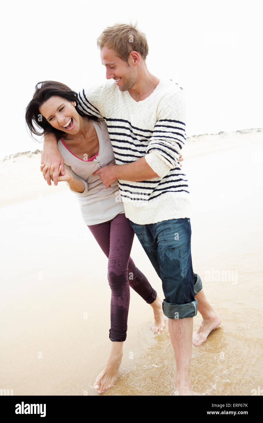 Couple Walking Along Beach Together Stock Photo - Alamy