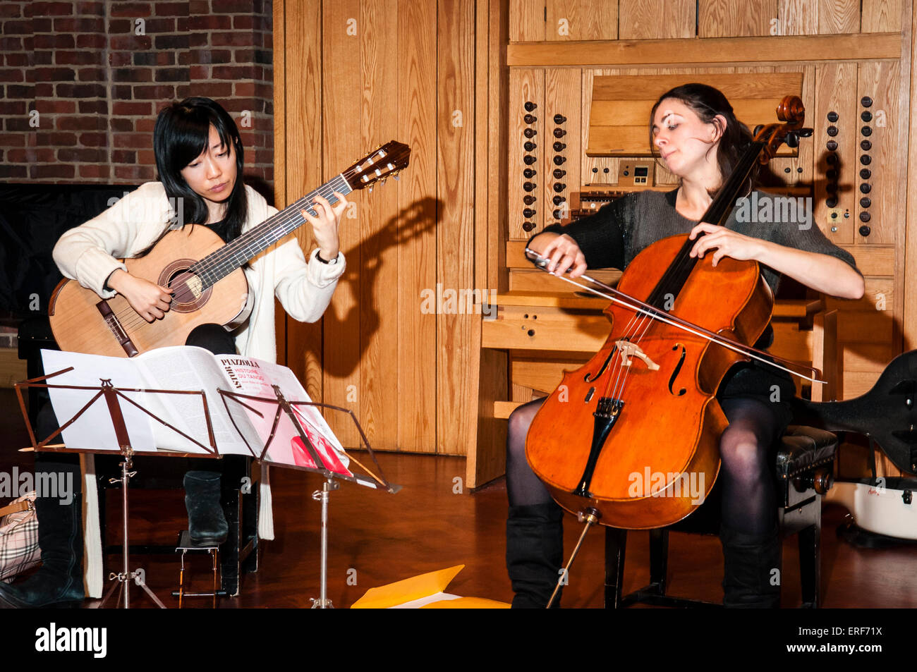 Xuefei Yang (Left) and Natalie Clein (Right) rehearsing together at the Turner Sims Concert Hall, Southampton, England. Stock Photo