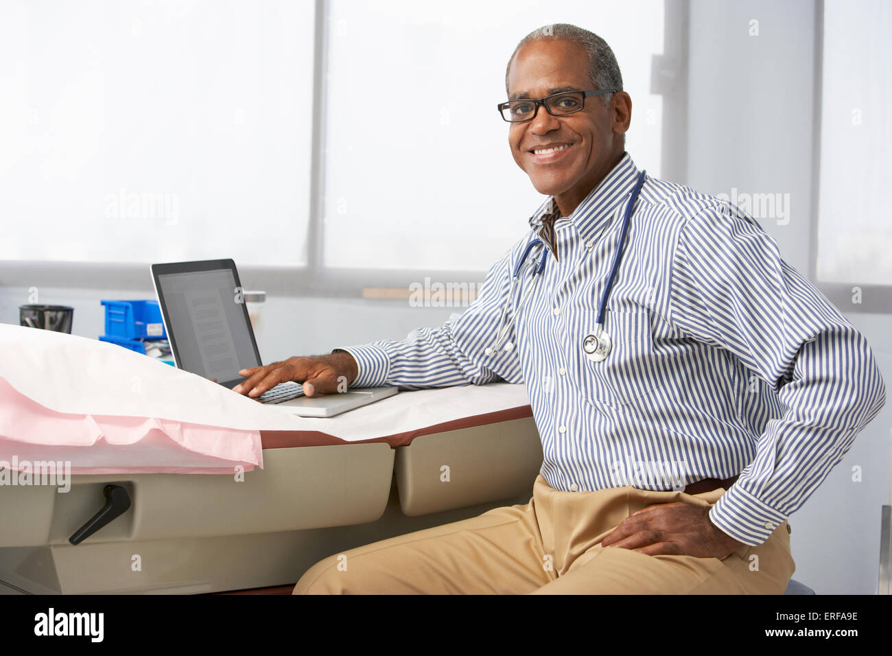 Happy doctor using stethoscope hi-res stock photography and images - Alamy