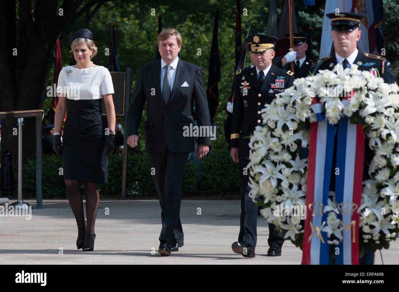 King Willem-Alexander, center, and Her Majesty Queen Maxima of the Netherlands stand with Maj. Gen. Jeffrey S. Buchanan, during a wreath ceremony at the Tomb of the Unknown Soldier in Arlington National Cemetery June 1, 2015, in Arlington, Virginia. Stock Photo