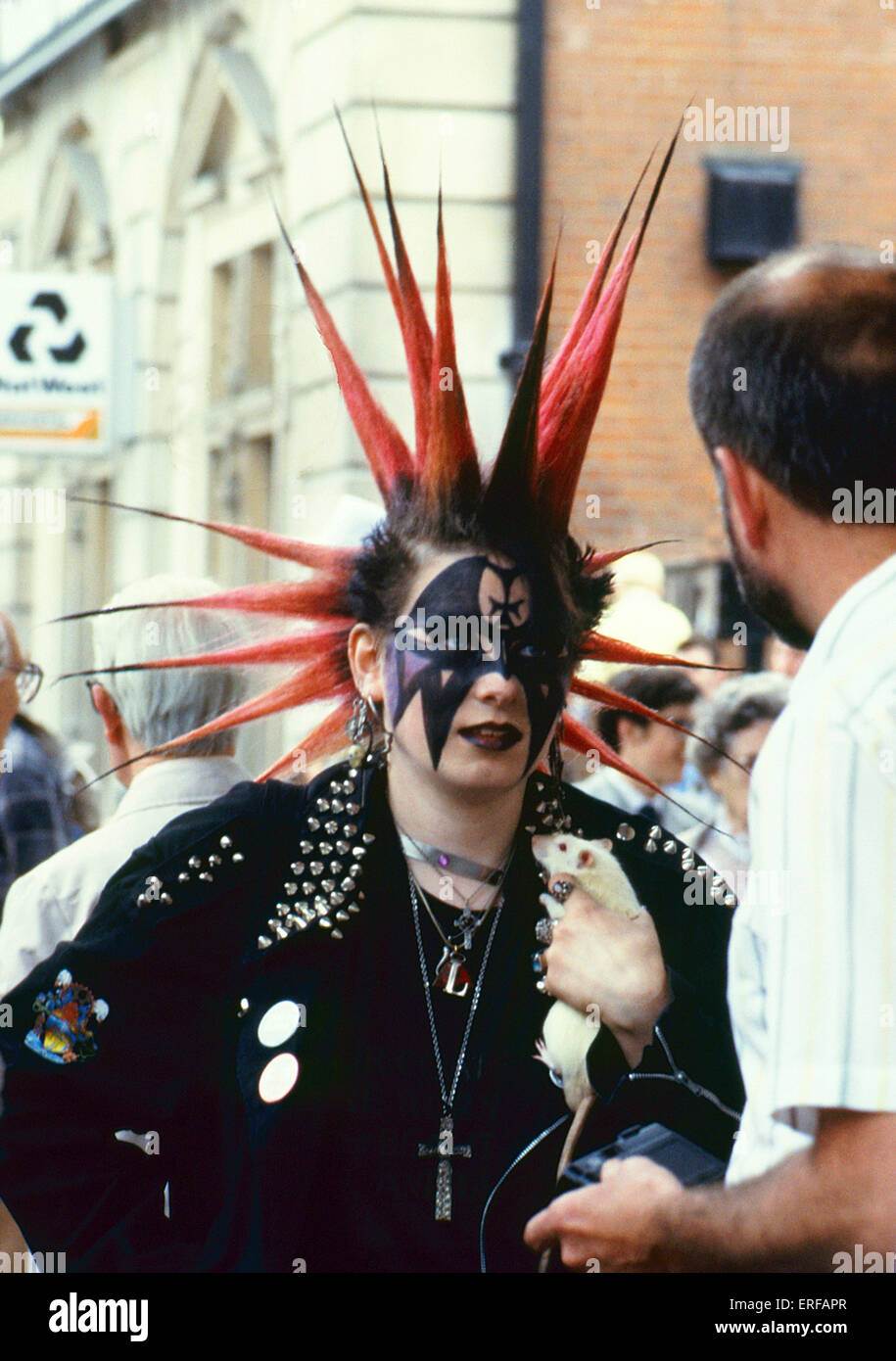 punk girl with red and black spiky hair and pet rat in covent garden ERFAPR