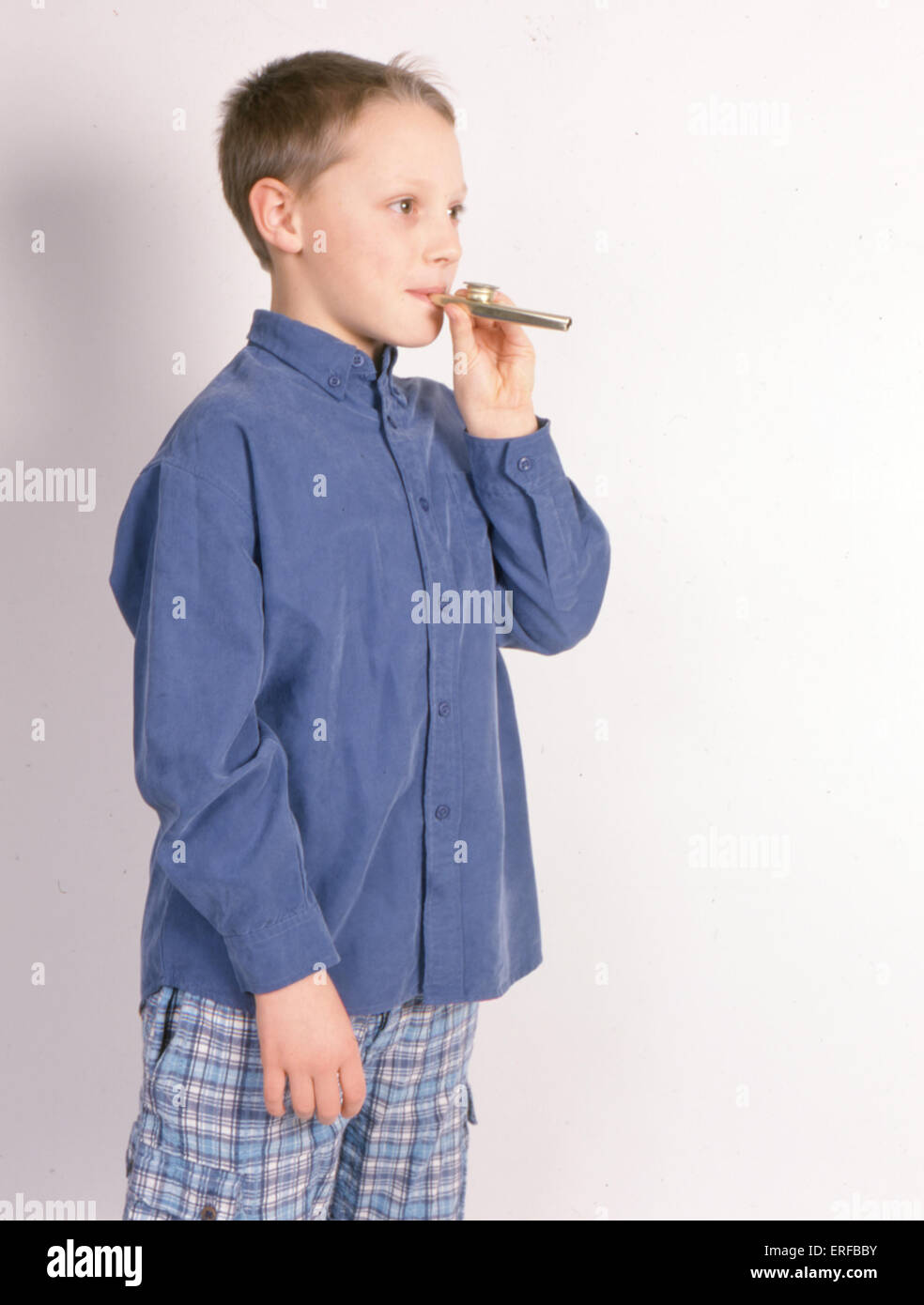 Primary school boy in blue clothes, playing Kazoo Children Alex Veasey