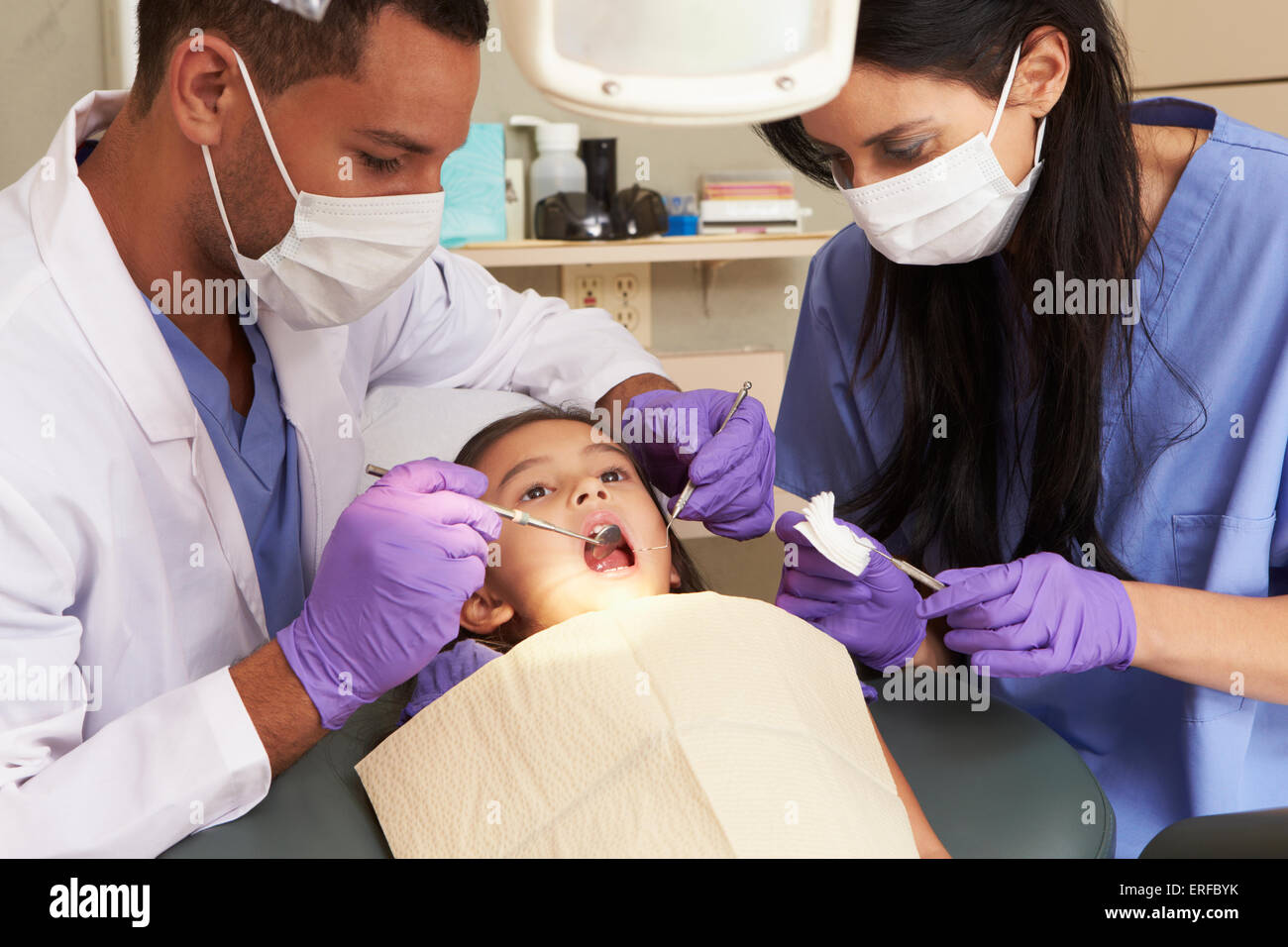 Young Girl Having Check Up At Dentists Surgery Stock Photo