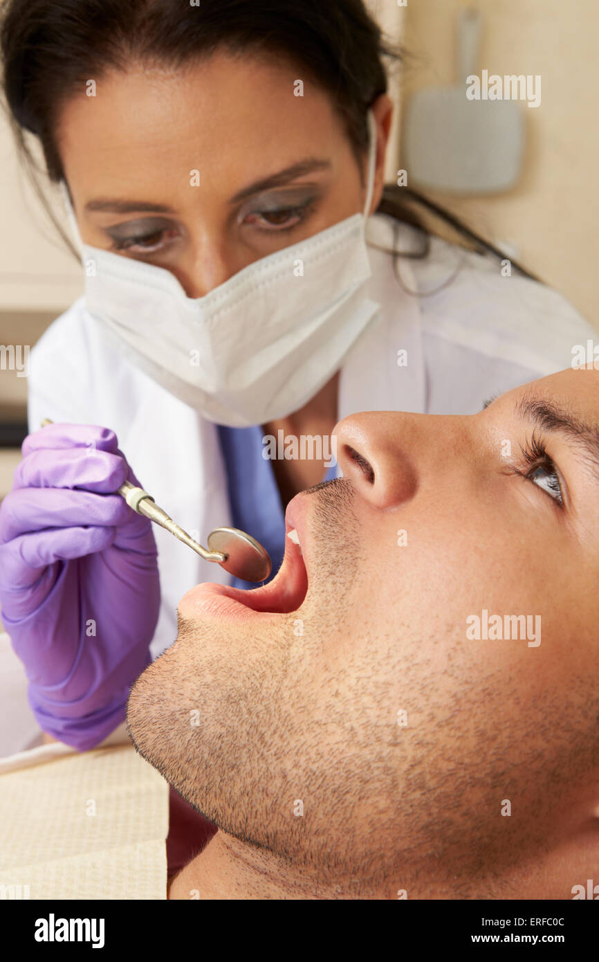 Man Having Check Up At Dentists Surgery Stock Photo
