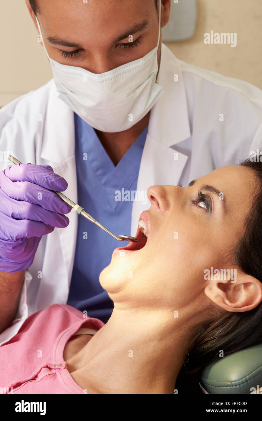 Woman Having Check Up At Dentists Surgery Stock Photo