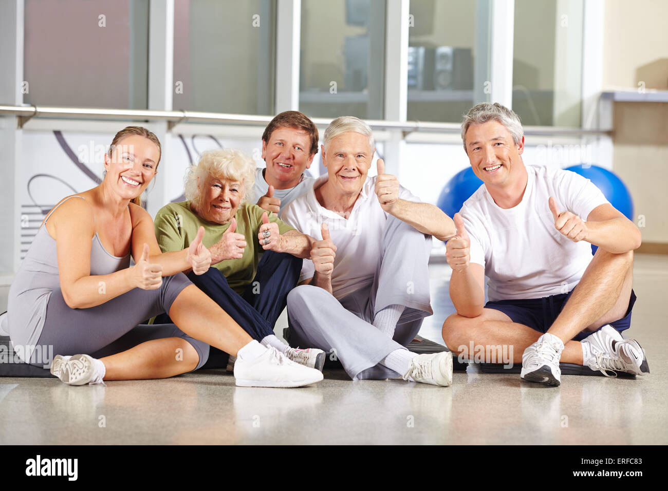 Group of happy senior people holding thumbs up in a gym Stock Photo - Alamy