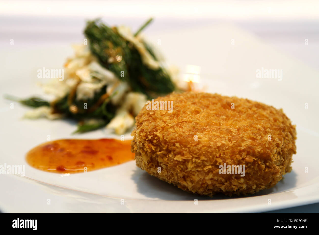 Delicious appetiser with some meat served in a white plate. Stock Photo