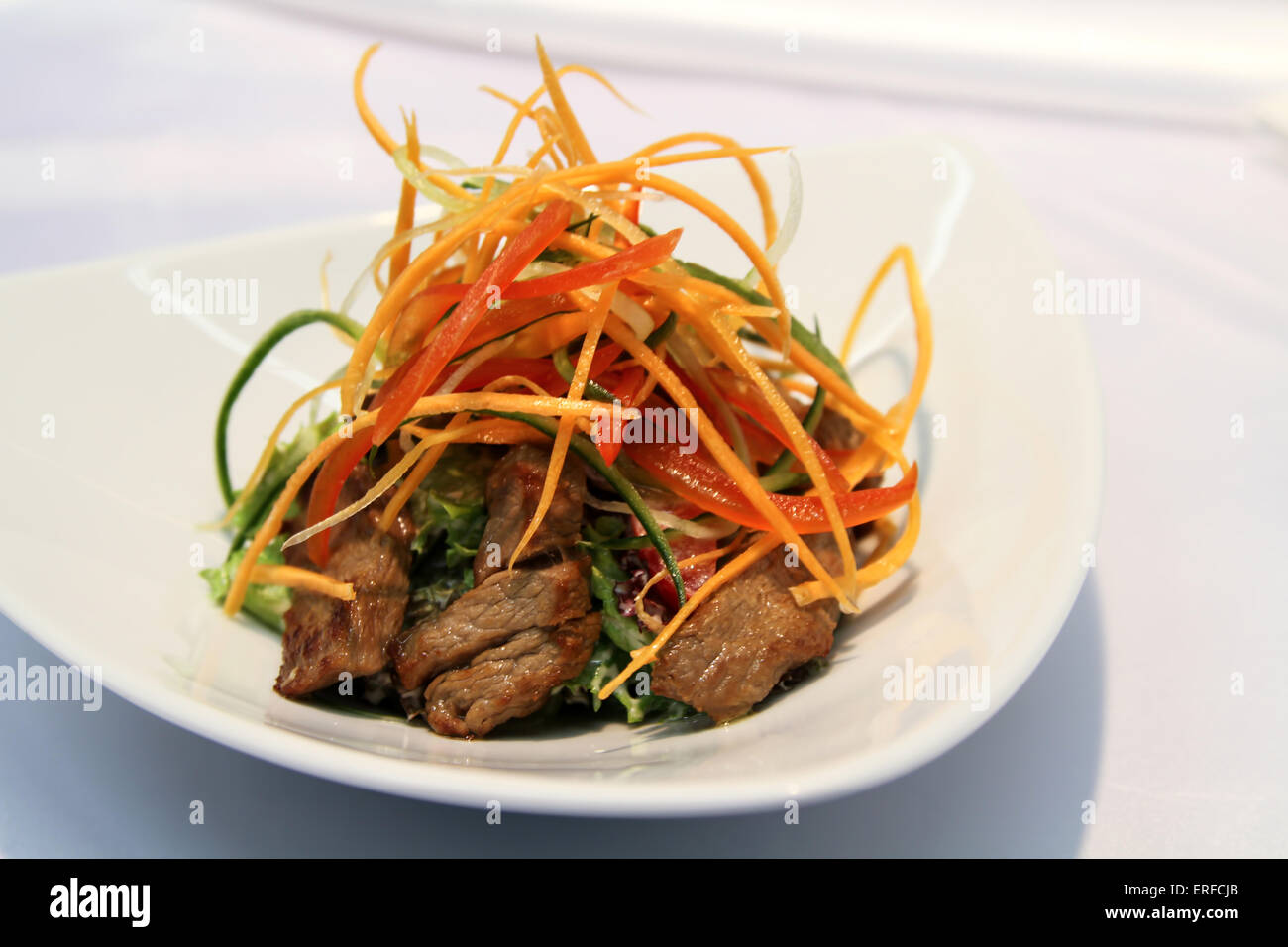 Delicious appetiser with some meat served in a white plate Stock Photo ...