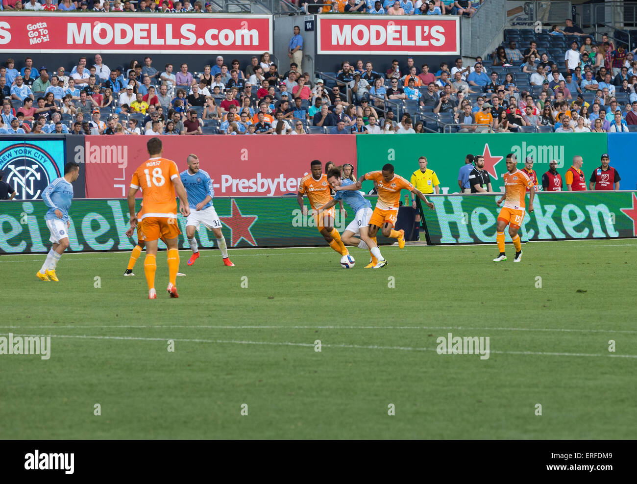 New York, NY - May 30, 2015: Mix Diskerud (10) of NYCFC & Ricardo Clark (13) of Houston Dynamo fight for ball during the game between New York City Football Club and Houston Dynamo at Yankee Stadium Stock Photo