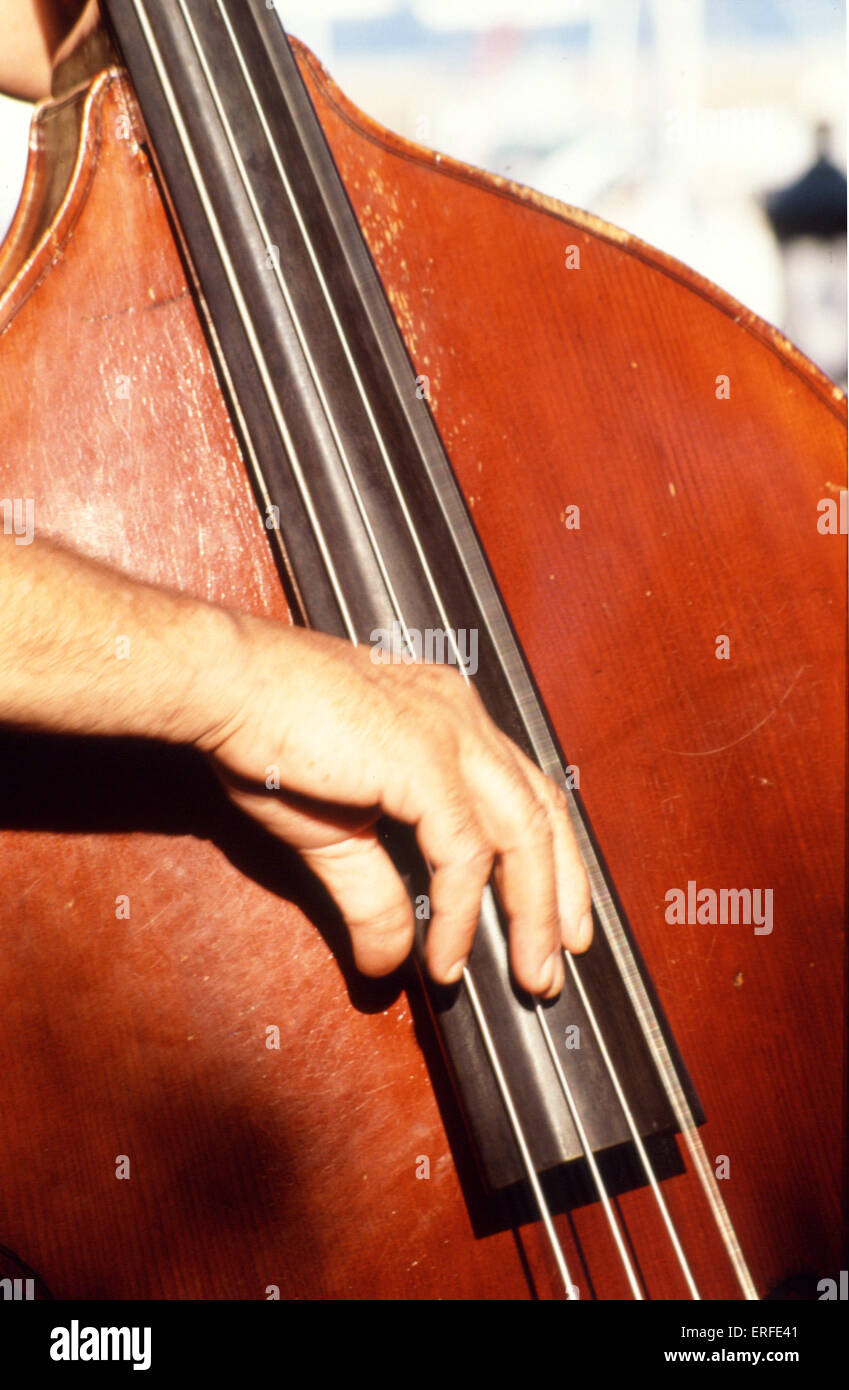 Close-up of pizzicato playing on double bass. (plucking). Stock Photo
