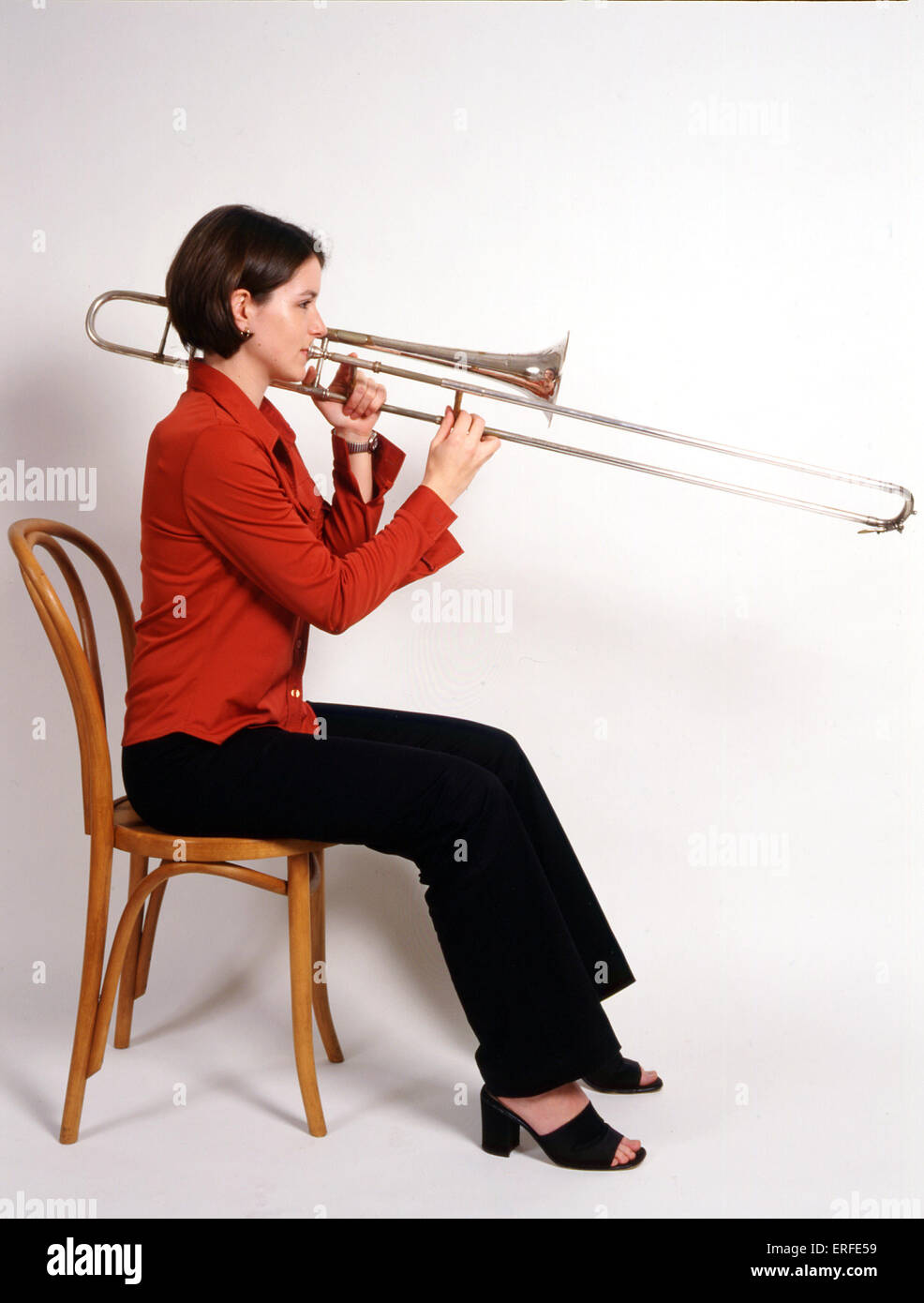 INSTRUMENTS BRASS TROMBONE Louise Williams playing trombone. Side