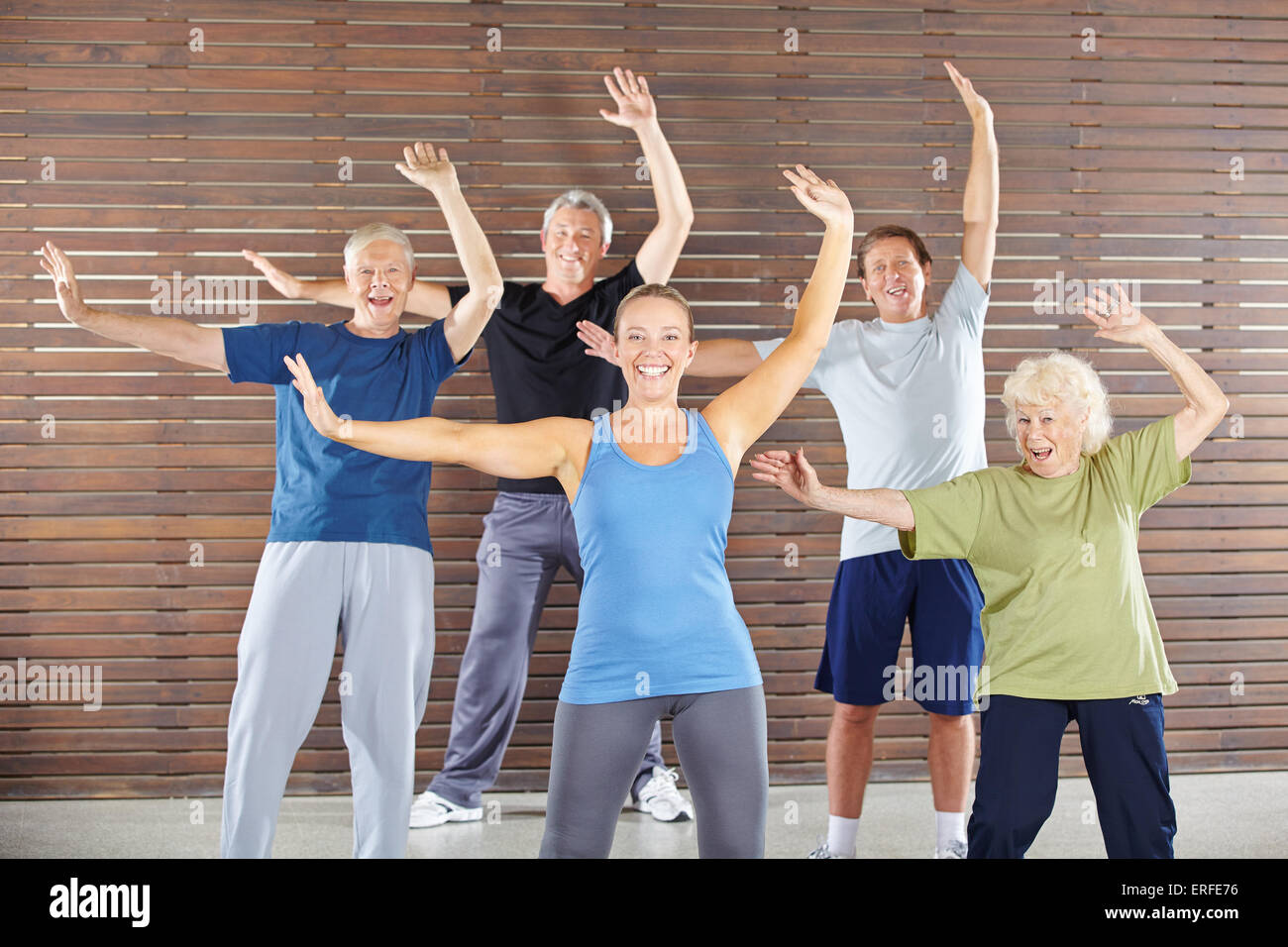 Group of happy seniors dancing and exercising in gym class Stock Photo