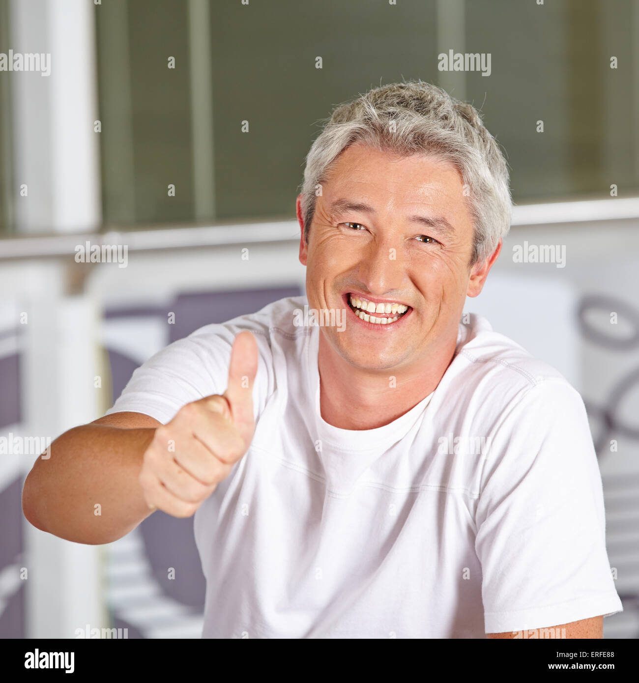 Elderly man holding thumbs up hi-res stock photography and images - Alamy