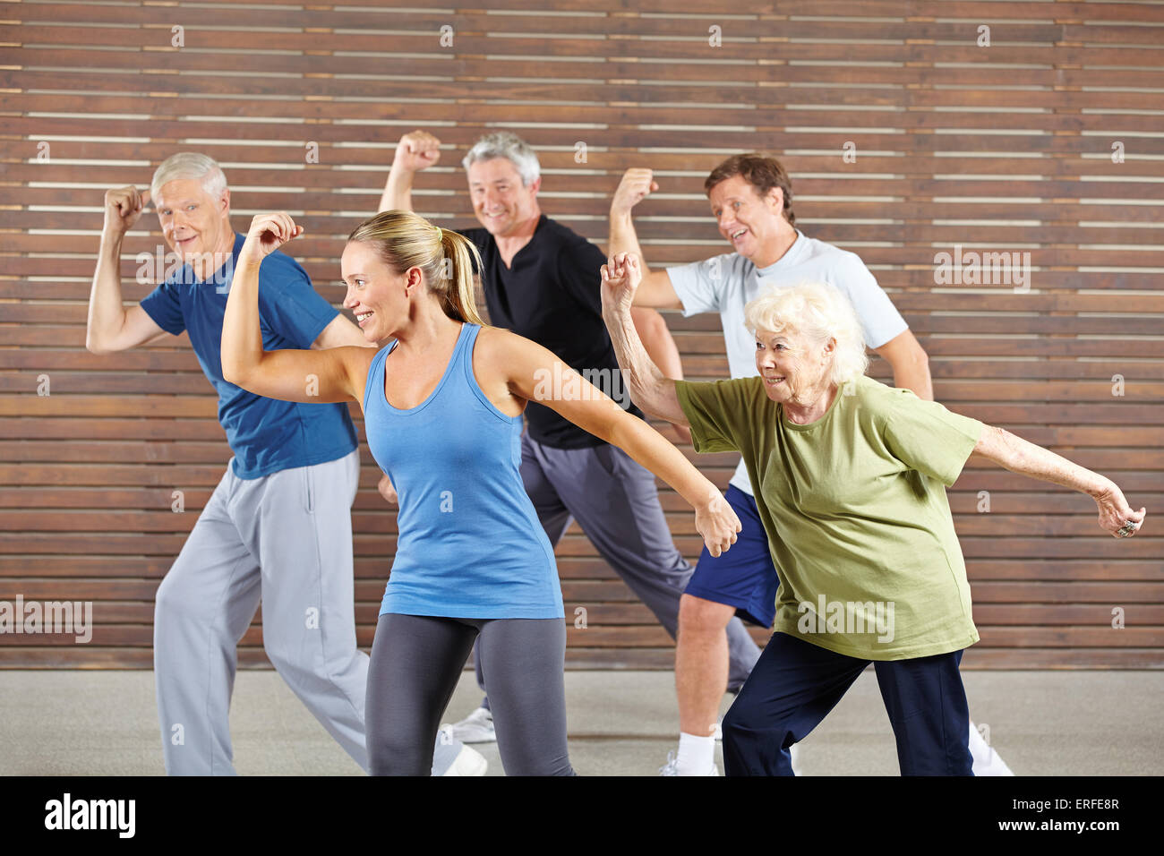 Happy senior people learning dancing in gym class Stock Photo