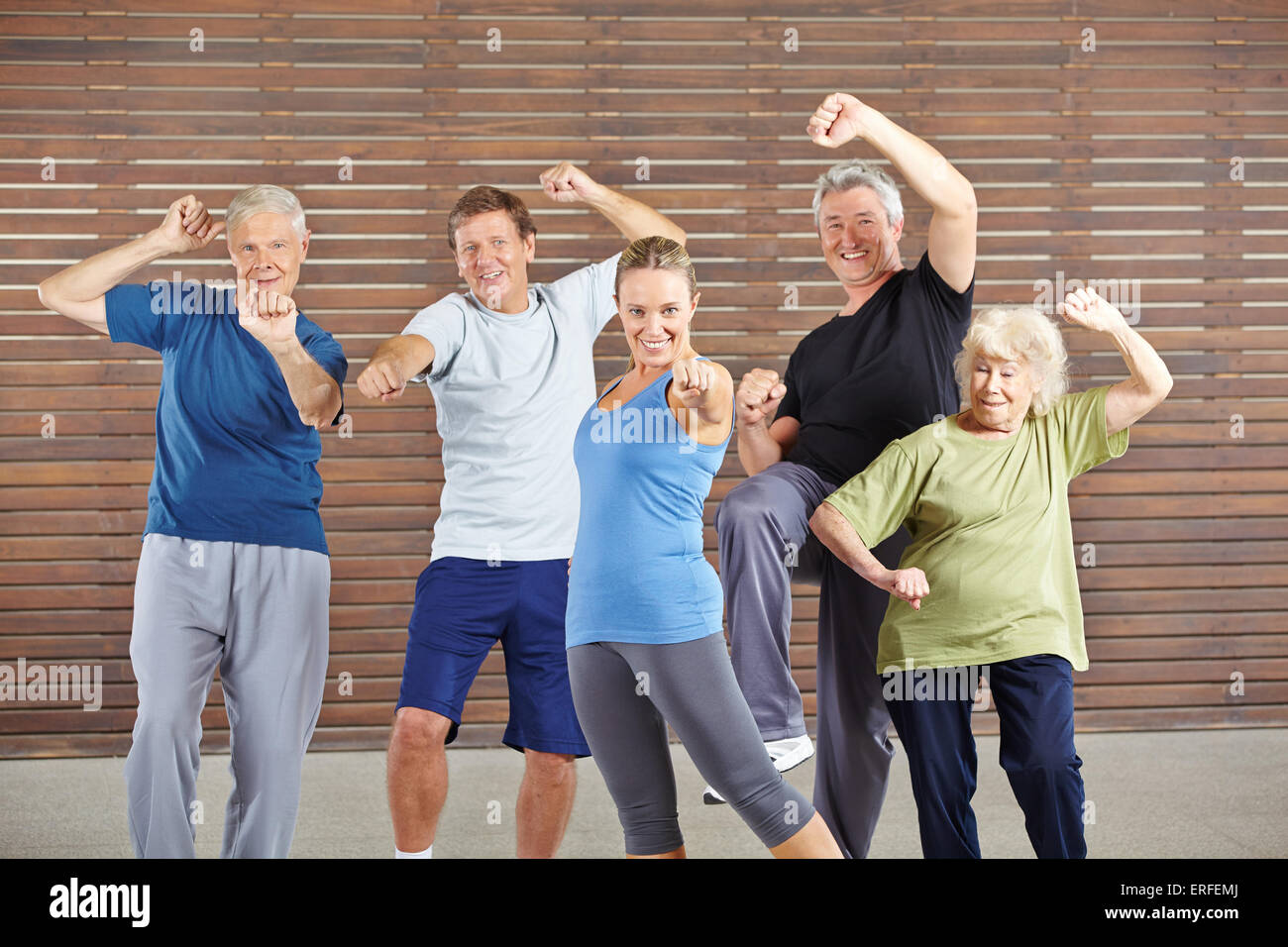 Active seniors with power and energy in gym learning self defense Stock Photo