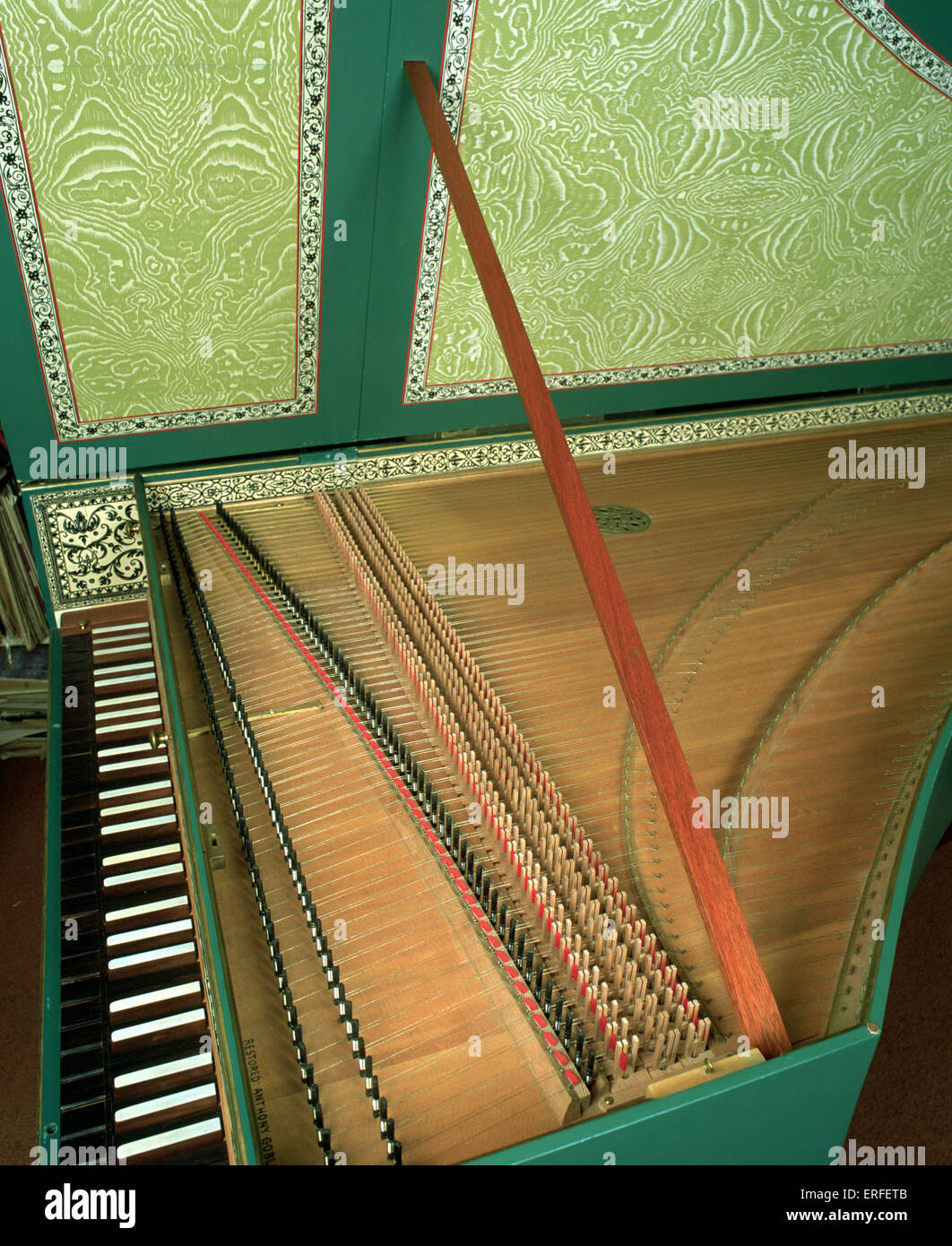 Harpsichord with open lid, showing strings, keyboard, soundboard and