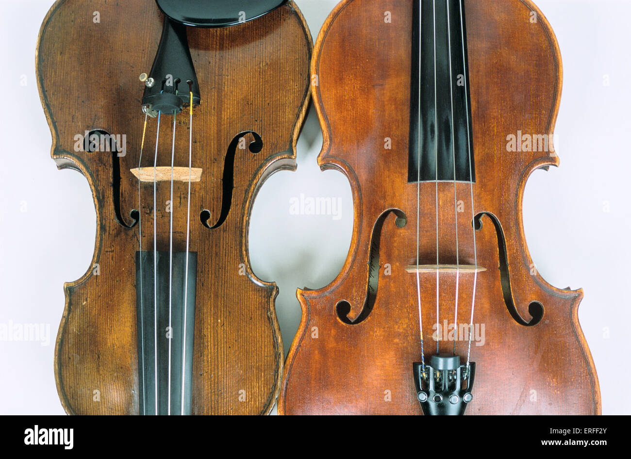 Violin and viola, side by side. Closeup of body of instruments