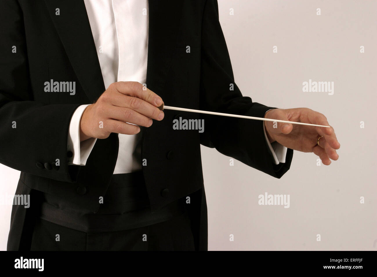 Conductor beating time with baton - Position of Beat 1. Shoulders and hands Suitable for cut out / silhouette. 2004 Stock Photo