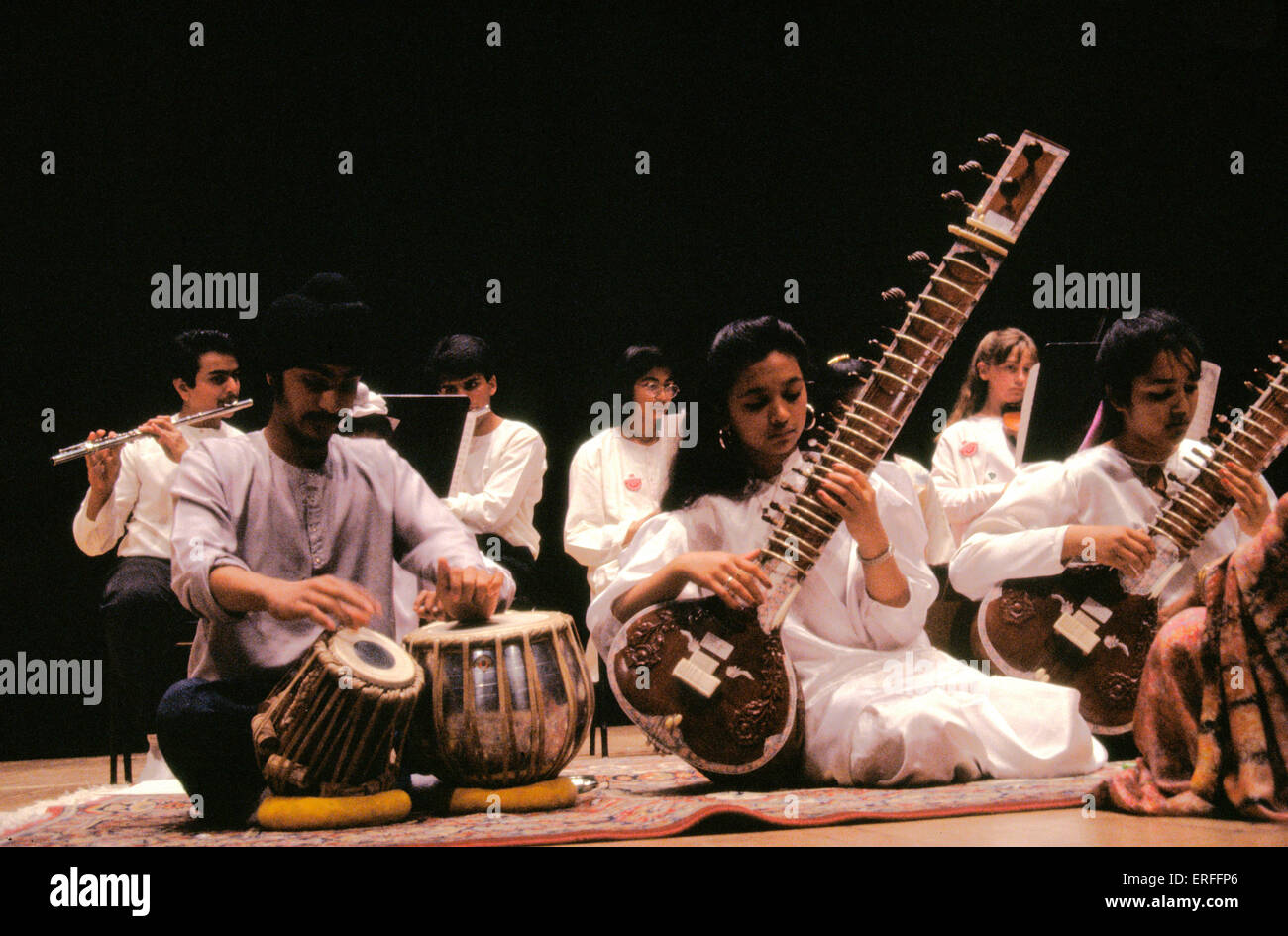 Indian group playing sitar, tabla wearing white Stock Photo Alamy